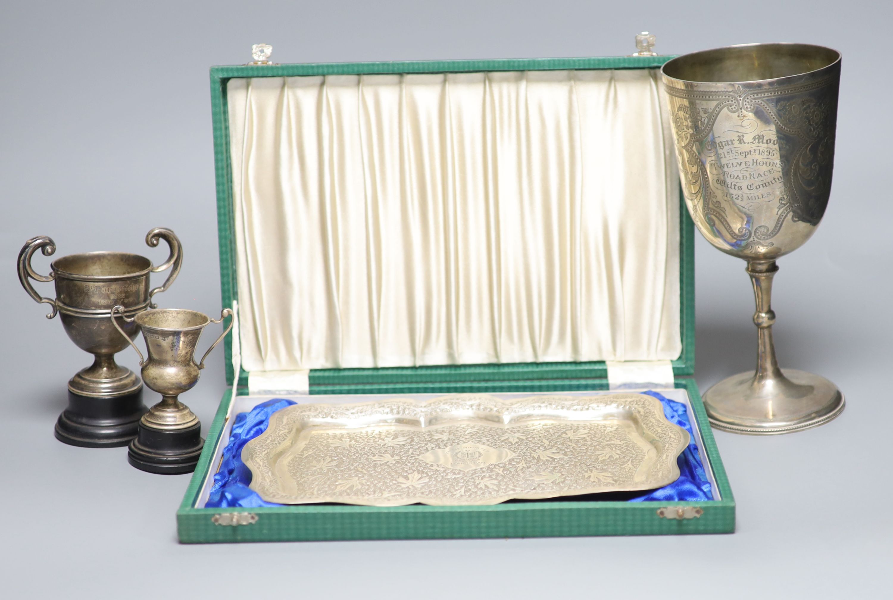 A Victorian engraved silver trophy cup, 'Twelve Hours Road Race', 1895, two small silver trophy cups and an embossed white metal presentation tray